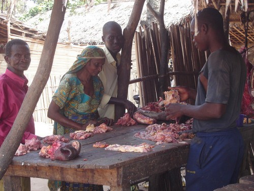 Old Mbororo woman buying meat in the market