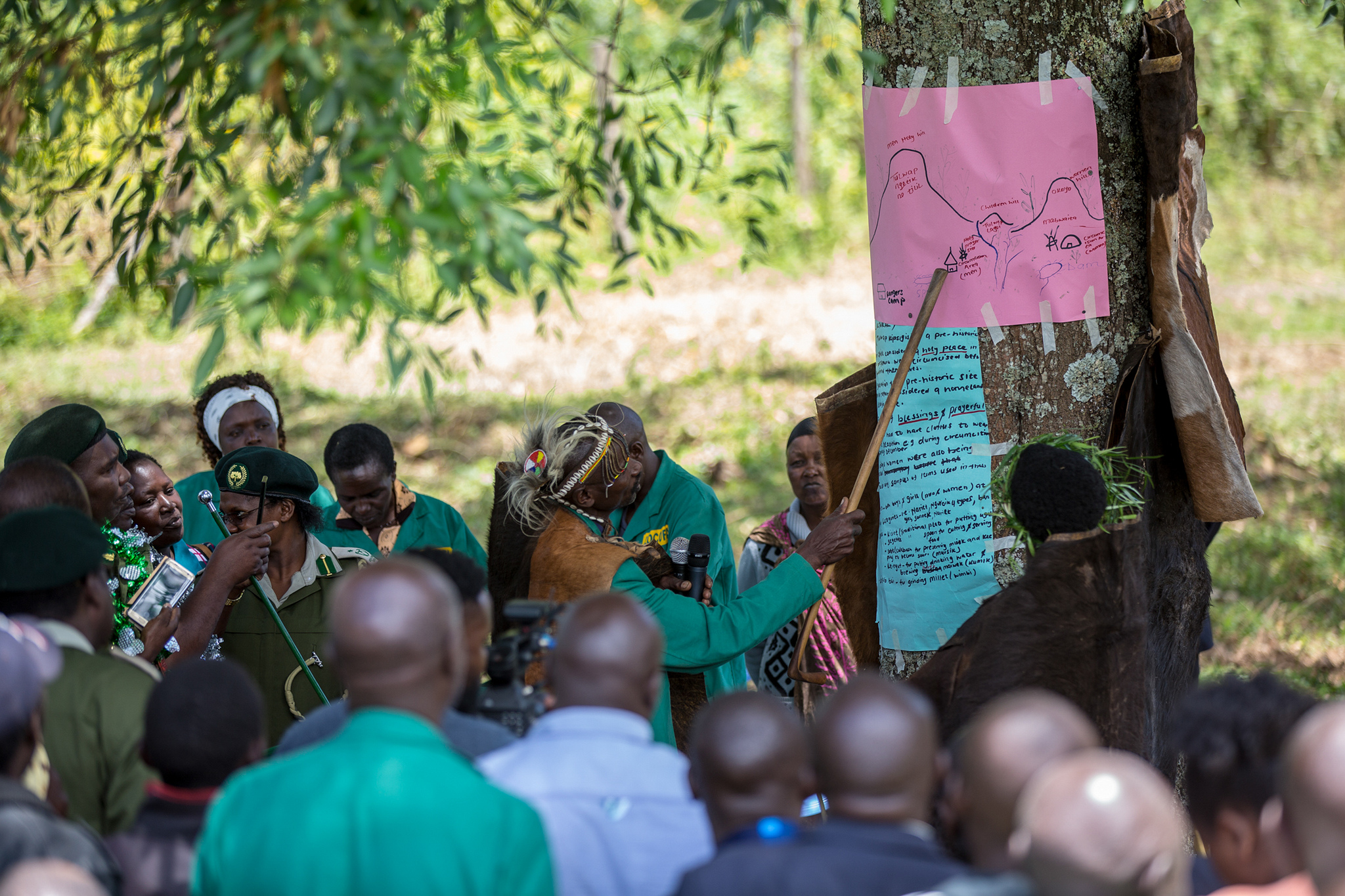 Community elder explaining the map of sacred hills in Londiani in Kenya's Rift Valley, on a tree to the community