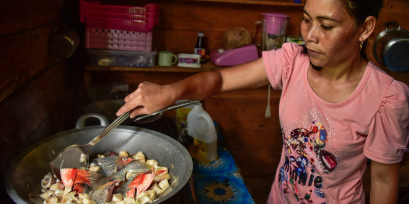 Changing diets in Kapuas Hulu Ibu Rosalina cooking fish with Keluwih.